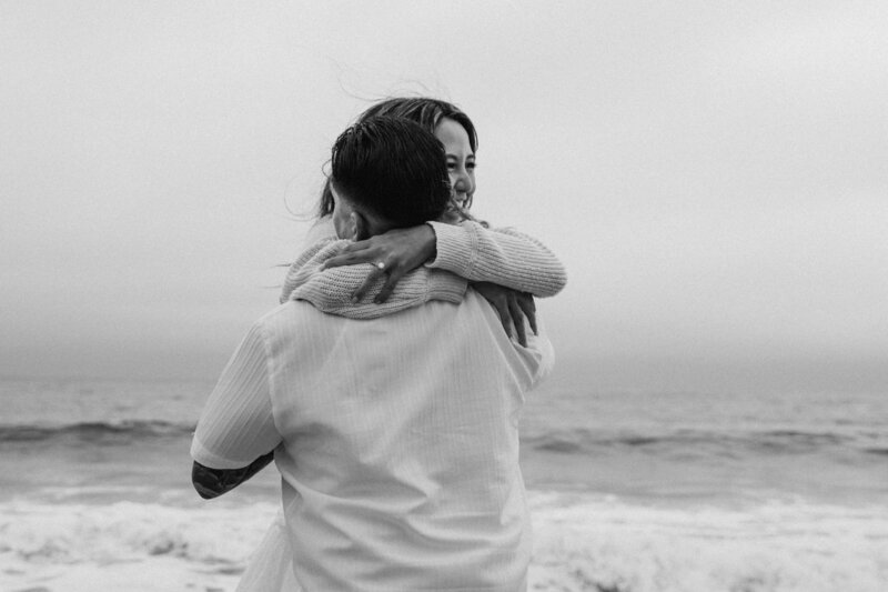 couple shares a kiss in the hills at sunset in California