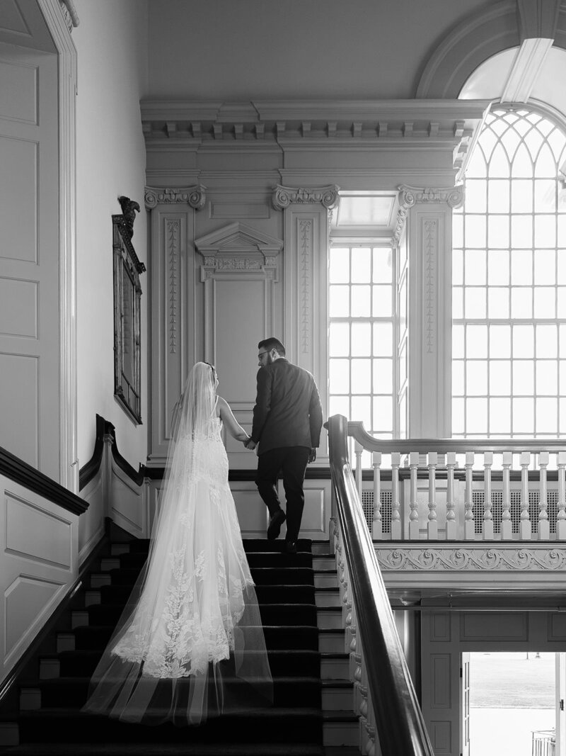 bride and groom walking up the stairs