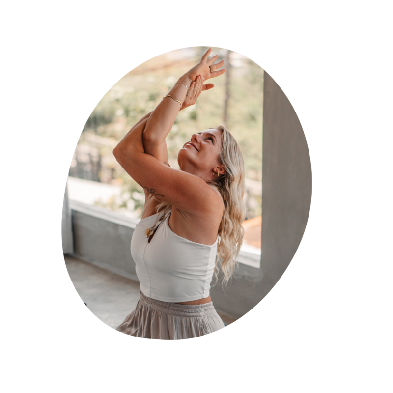 Women in white dress sitting on stairs by the beach