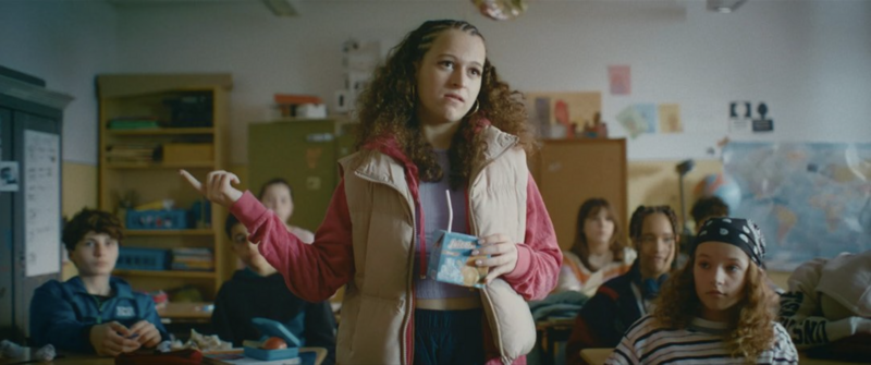 A group huddle before a match, emphasizing unity and youthful determination.