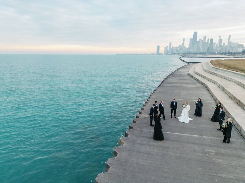 An overview shot of the bridge standing on the boardwalk surrounded by the guests with the view of Chicago, IL in the background.  