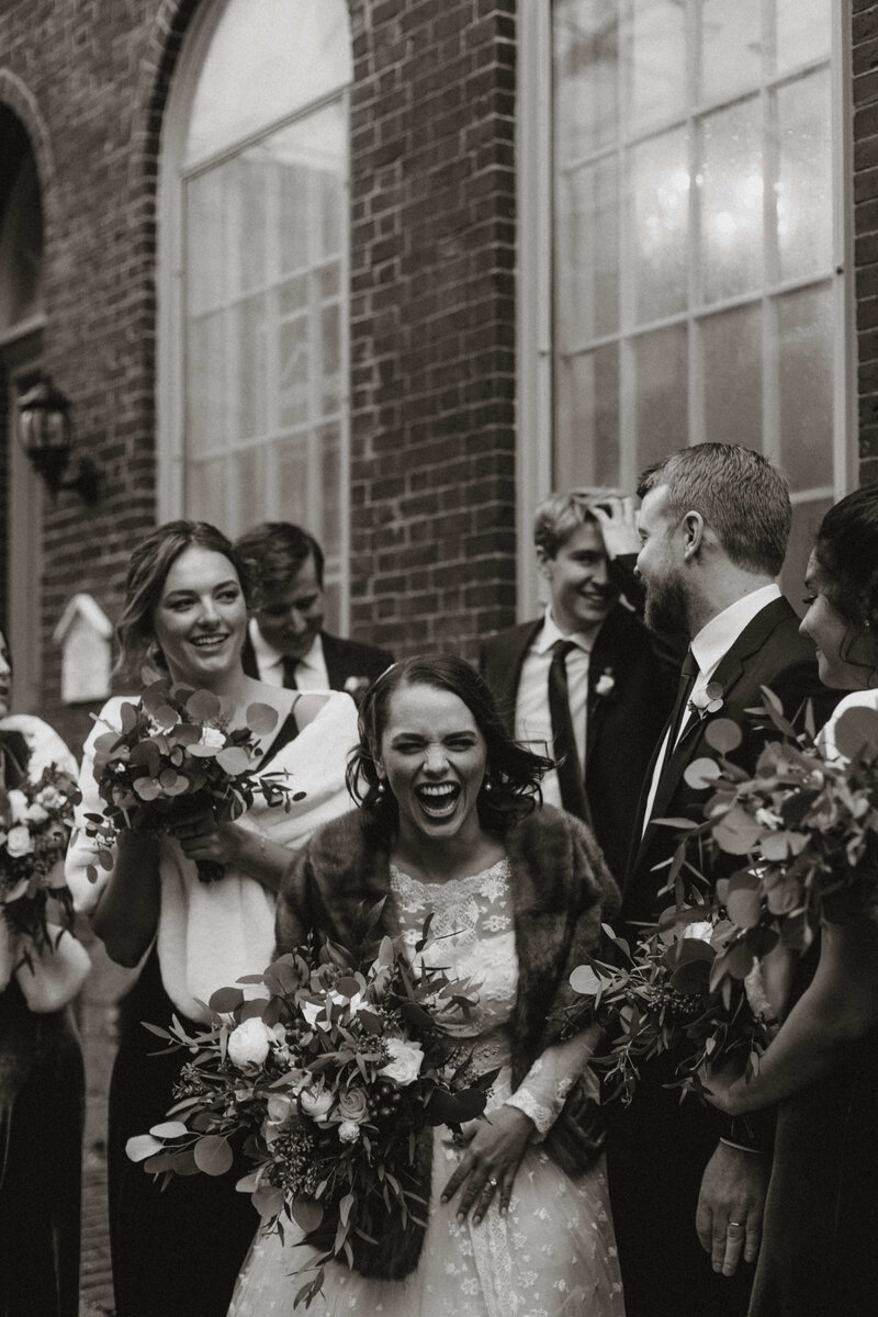 A Boston bride with a huge smile surrounded by bridal party