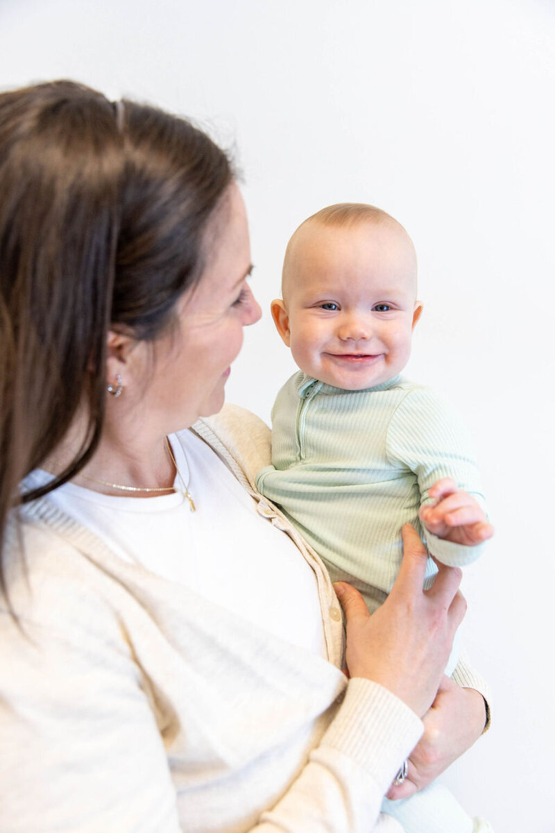 Woman holding her smiling baby