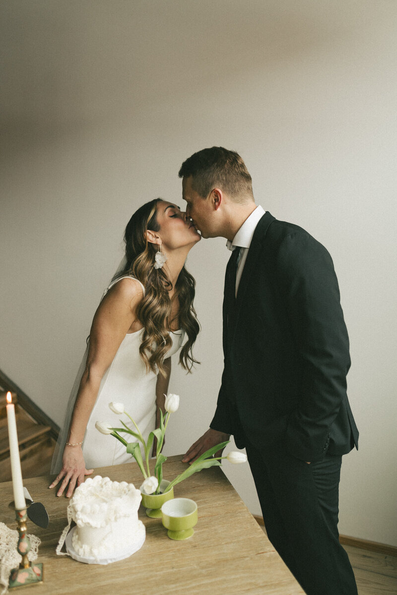 fernie wedding couple kiss before cake cutting captured by fernie wedding photographer