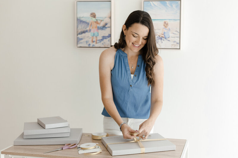 Nicole wrapping a box with prints
