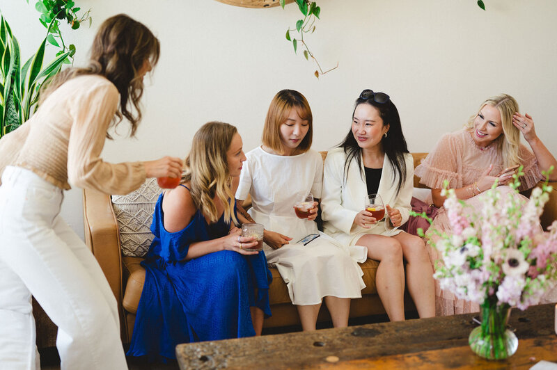 Cassandra sitting on stage with beauty founder, talking