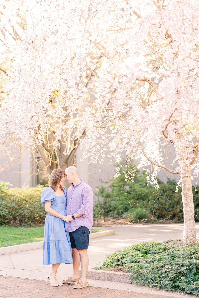 Couple standing under a blooming tree for a Dayton, OH photographer