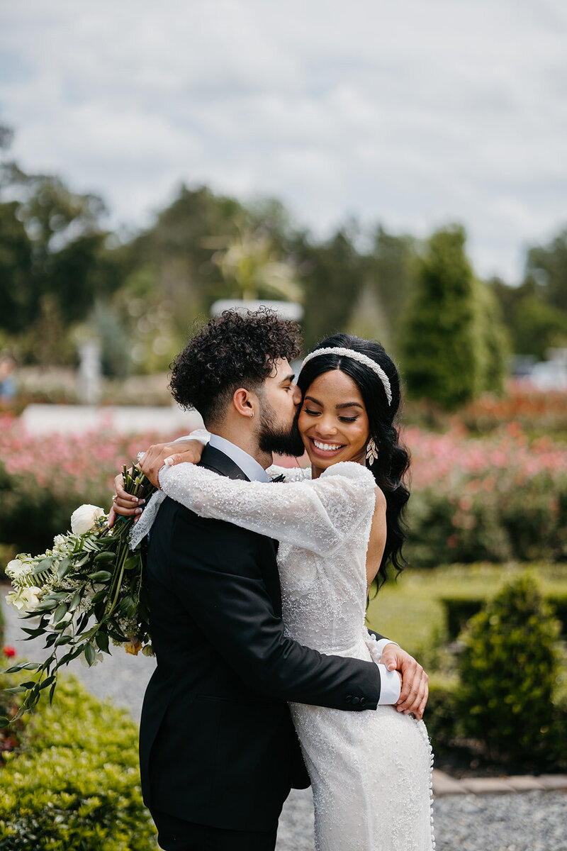 bride and groom smiling outside
