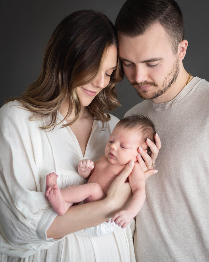 adorable family portrait in downtown mckinney against interesting wall