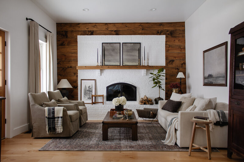 Living Room renovation by Nadine Stay. Brick fireplace and wood feature wall. Neutral living room before and after.