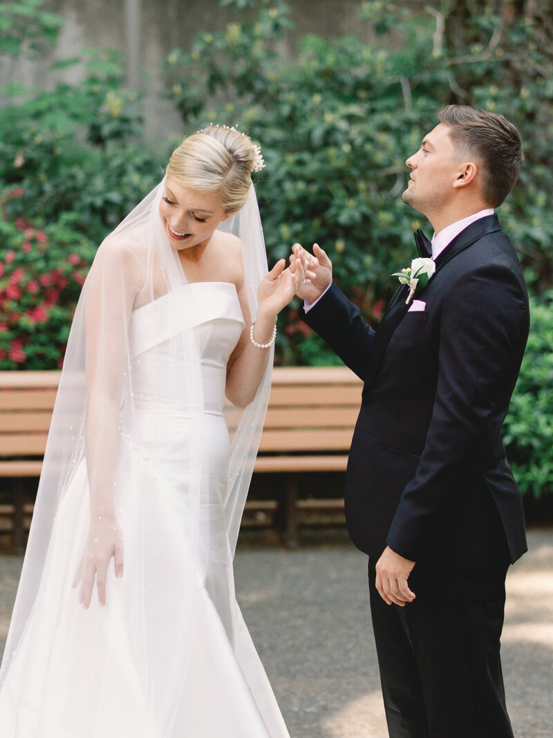 modern bride wearing her Grandma's 1950's wax flower crown restyled into a hair comb and showing her Groom