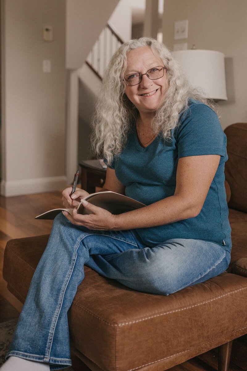 Michelle Krieger Dragonfly Ventures owner & Profit First Bookkeeper writing in a notebook