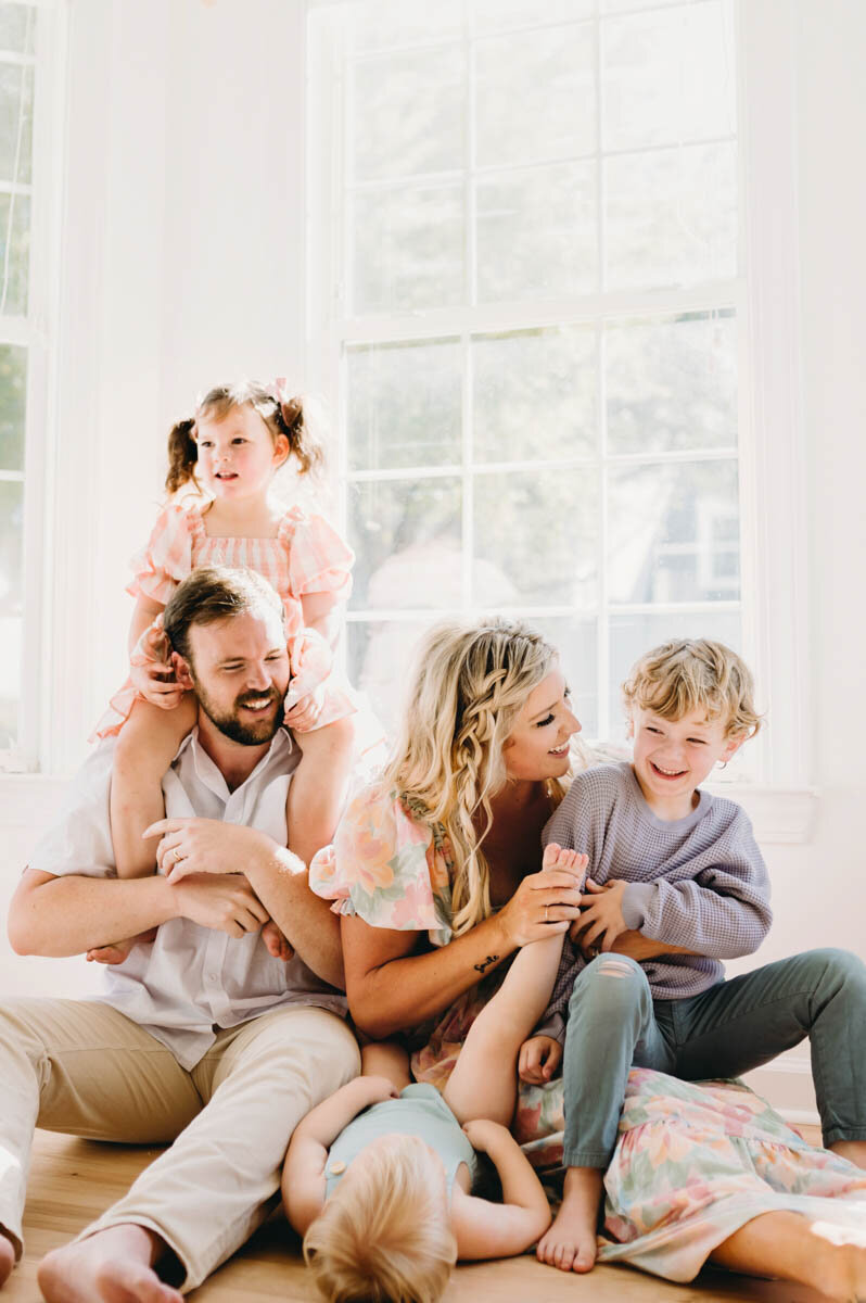 family of five playing on the floor by a window - photo by NPS Photography