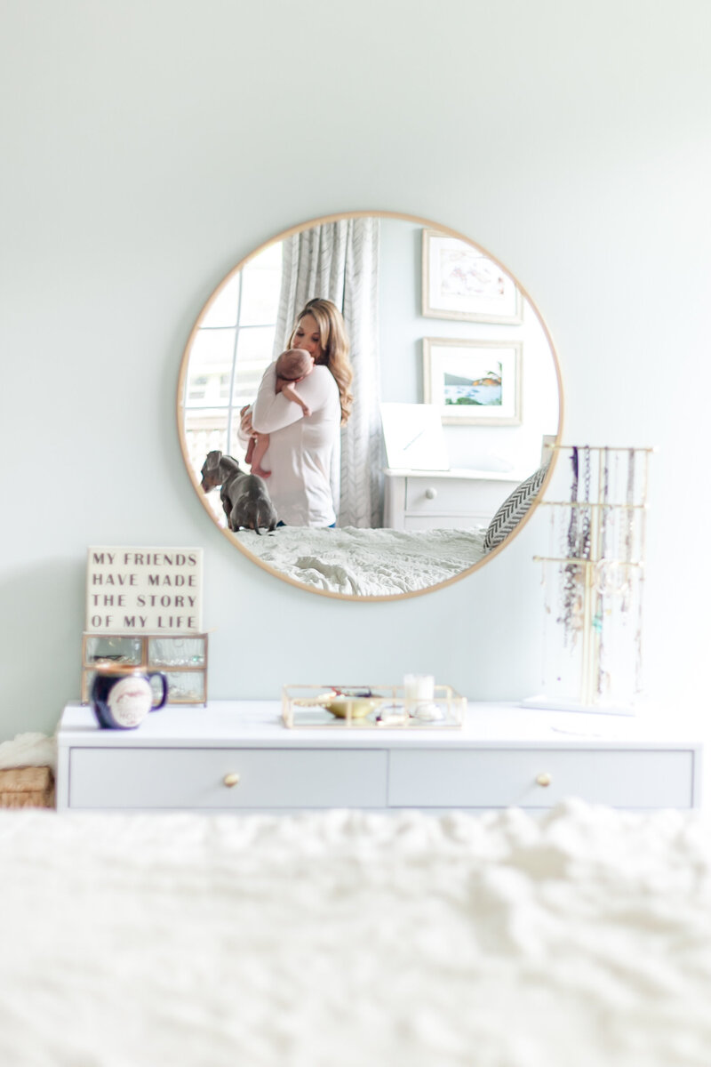 Mom holding her newborn in the mirror reflection – Columbia SC family photography.