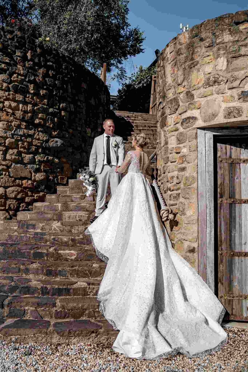 Bride and groom hugging each other.