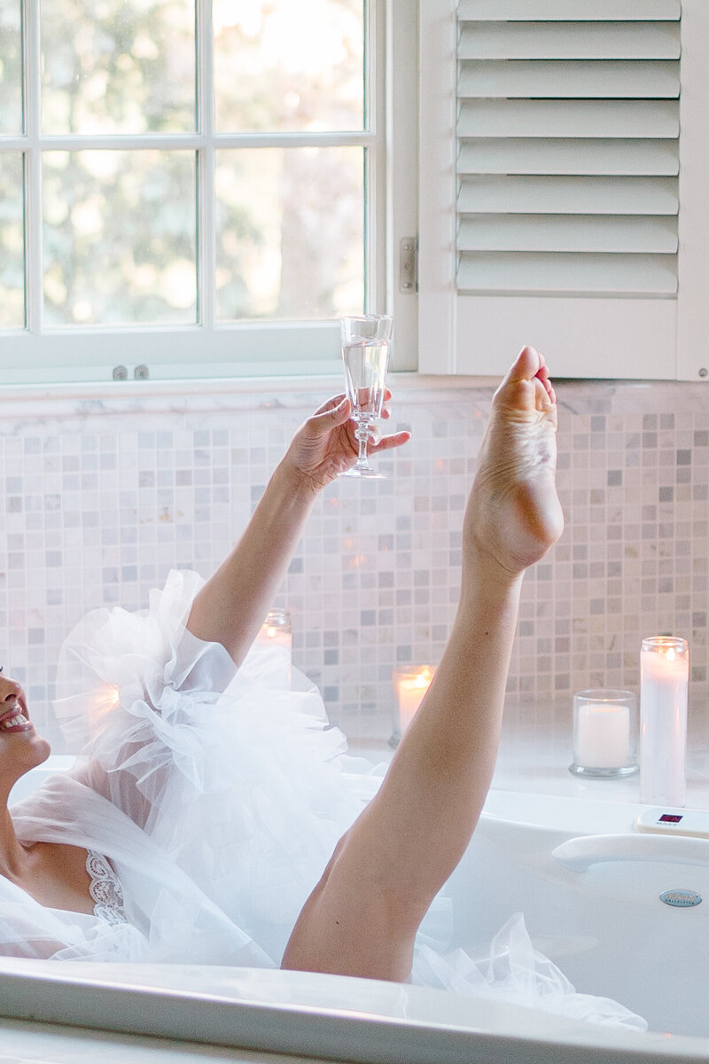 Wedding Photographer Newport RI | Rhode Island Caprio Captured Photography | Bride in a Bathtub Holding a Champagne Glass In a Tulle Robe