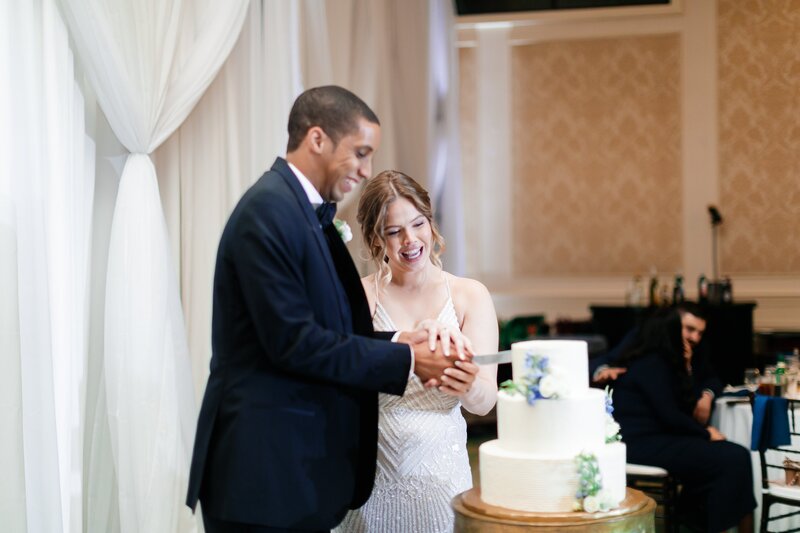 Bride and groom cutting their wedding cake