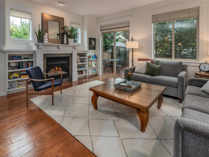 A living room featuring a fireplace, couch and wooden coffee table.