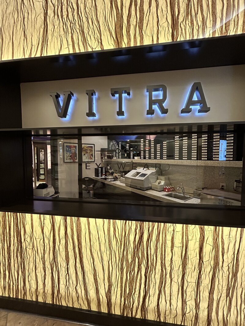 Shot outside of Vitra Eyeywear location looking into the area where their glasses receive lenses.