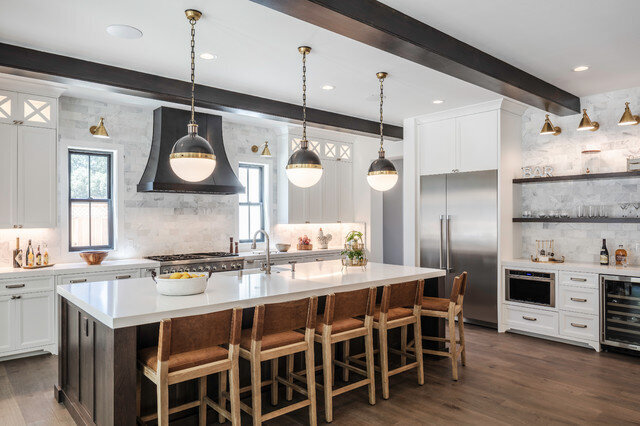 Kitchen remodel and design with white walls and countertop with black accents.