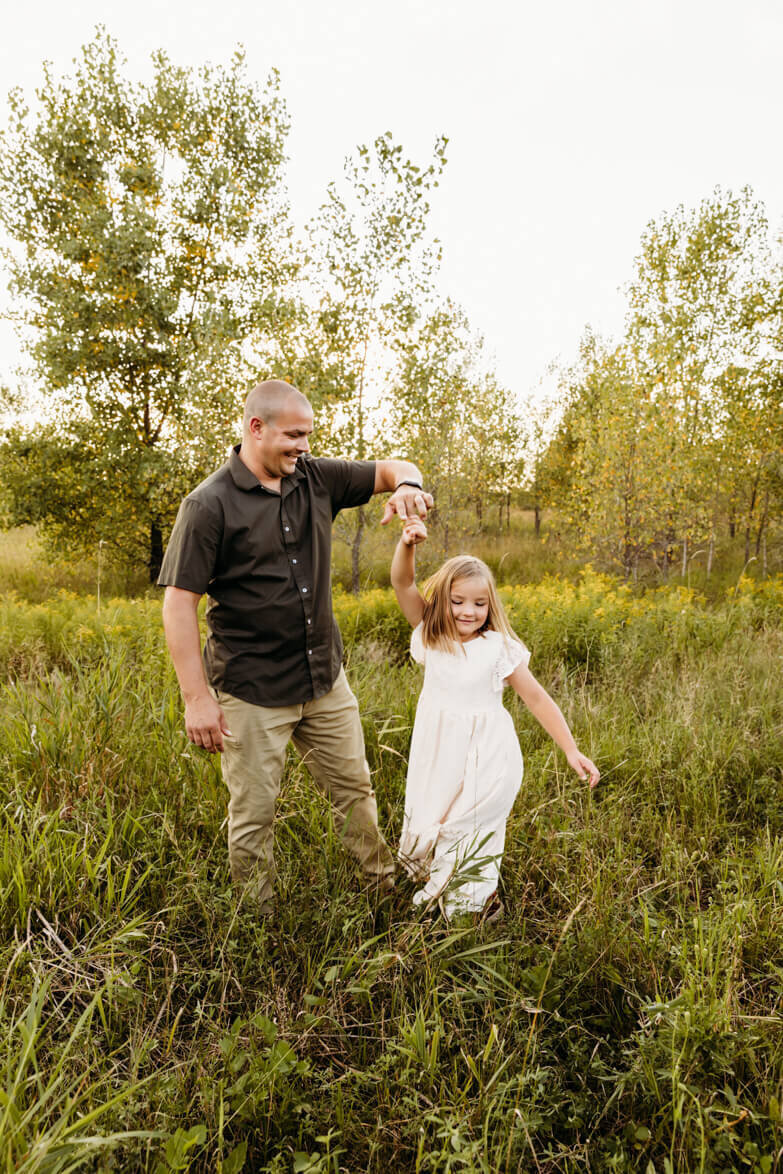 dad twirling his daughter for family session in Appleton