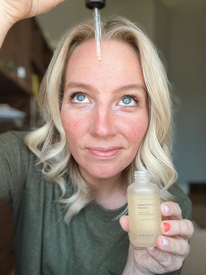 Kelsey Hansen applying the Dermatology Serum EX to her face