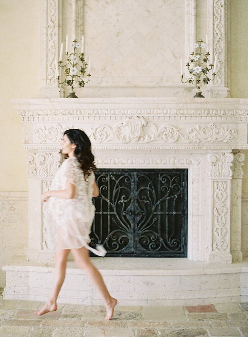 Model photograph in front of antique fireplace and mantle.