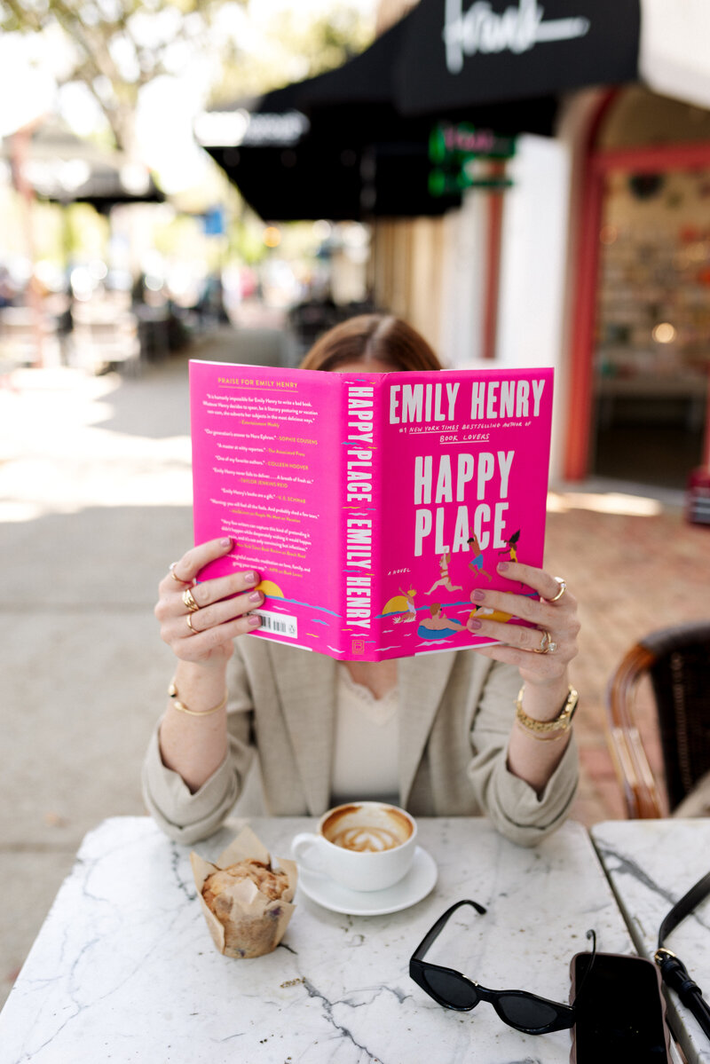 Girl reading Happy Place by Emily Henry