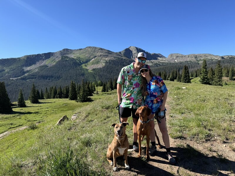 couple with dogs on trail