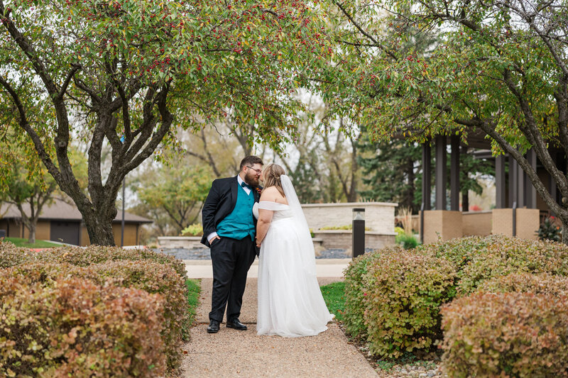Claire Katan captured a sweet moment between a bride and groom for their wedding portrait at Dakota Dunes Country Club.