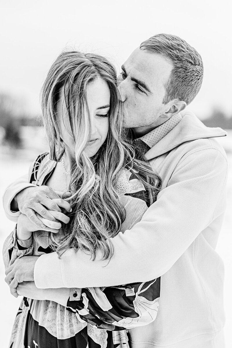 couple-cuddling-in-winter-at-centennial-pines-tree-farm