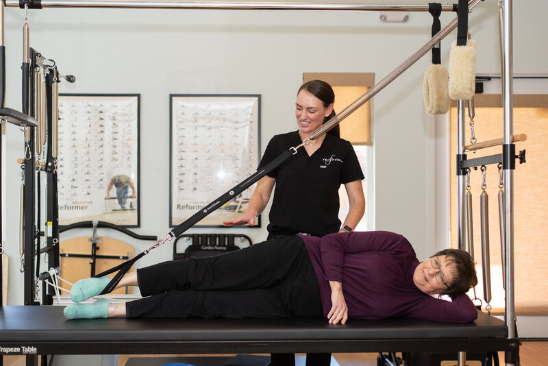 Pilates instructor does a private session with a client