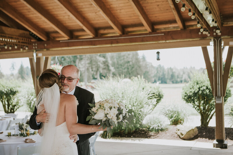 real bride wearing a floor length veil and sharing a first look with the father of the bride