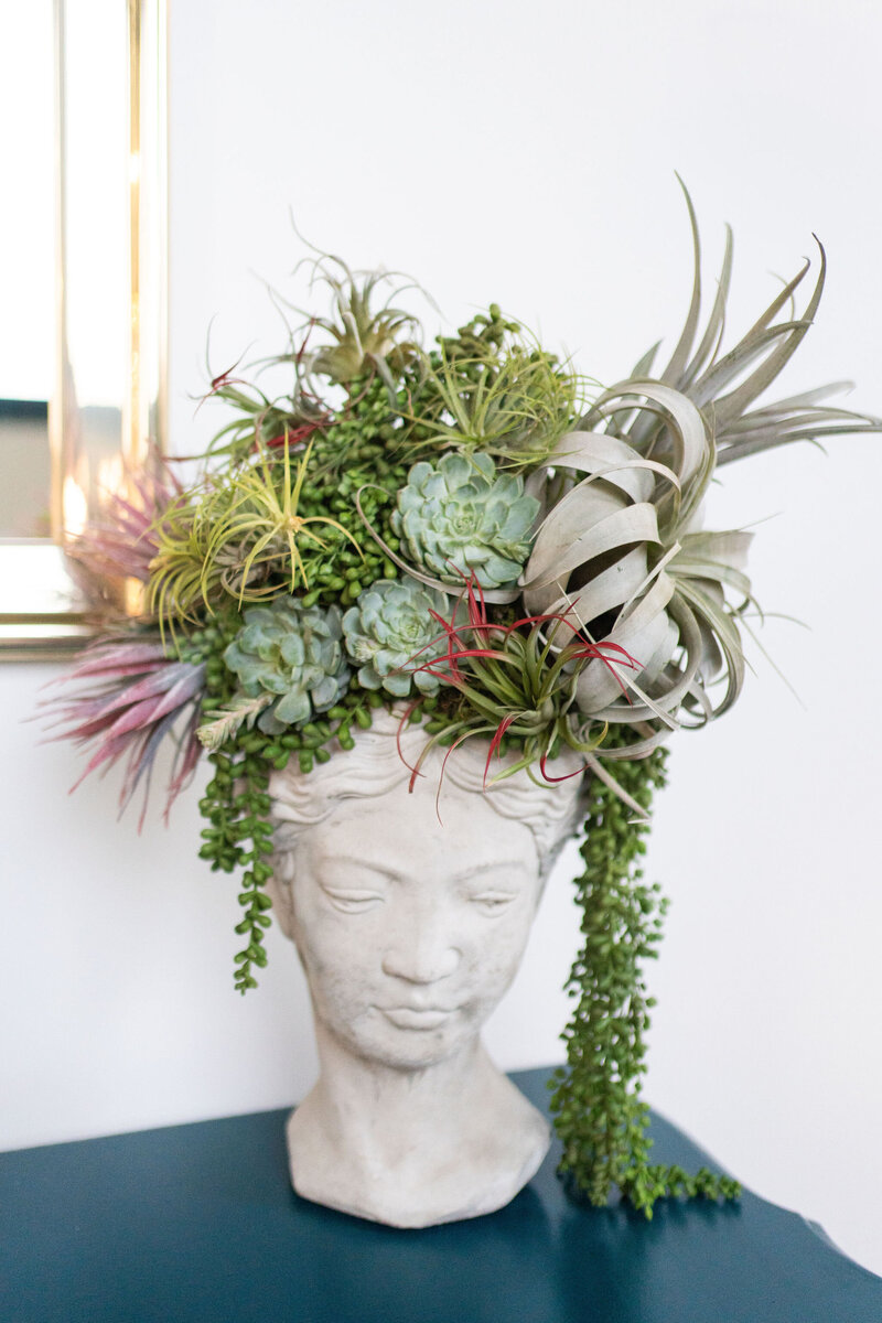 vintage bust designed with luscious succulents and plants to accent venue entryway