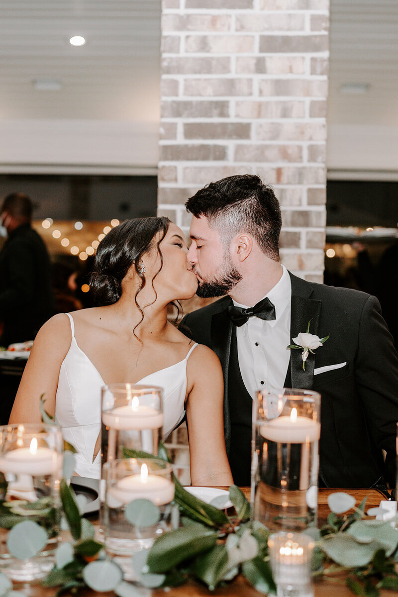 Swank Soiree Dallas Wedding Planner Haile and Christian - kissing at reception dinner