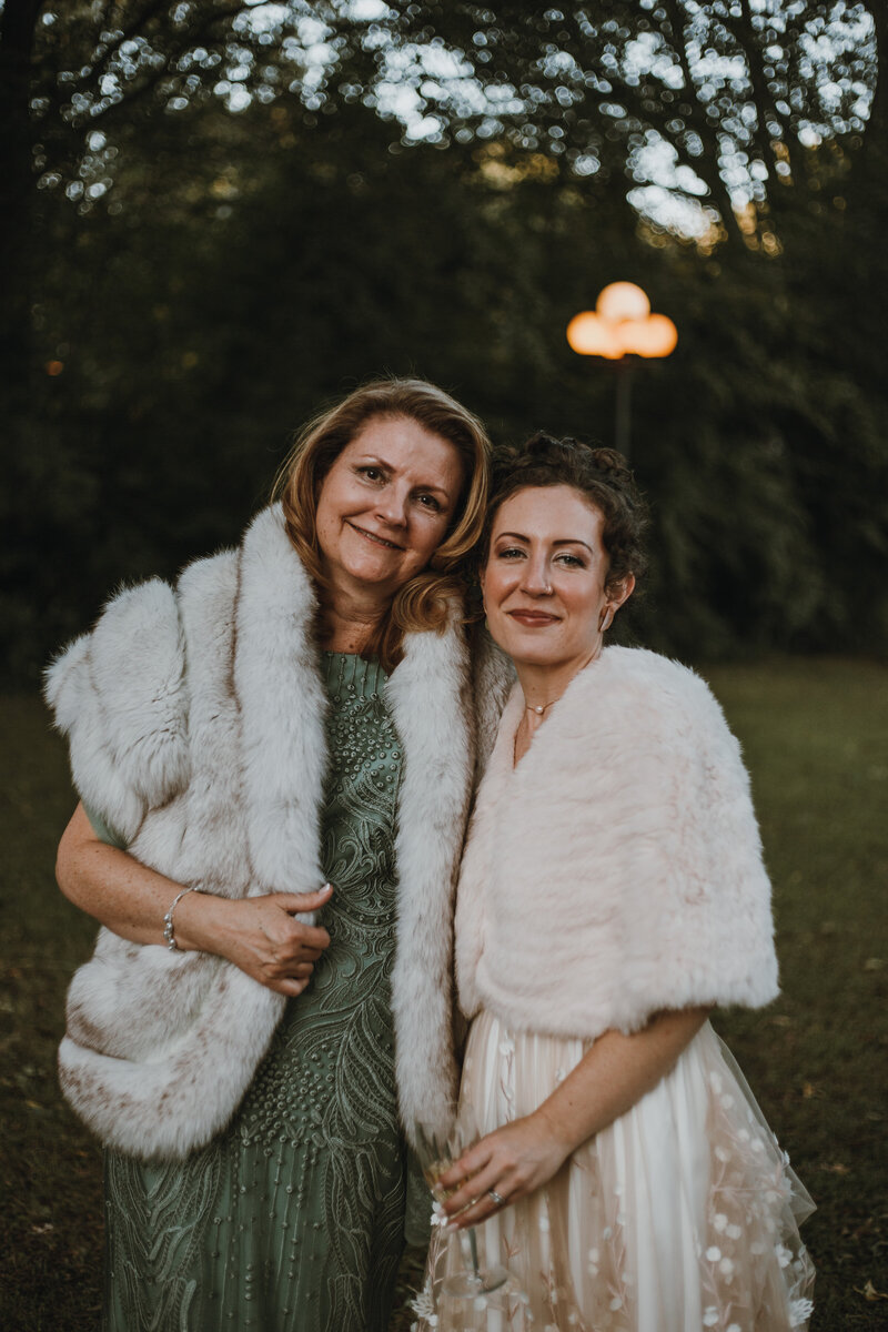 bride and her mother smiling in garden