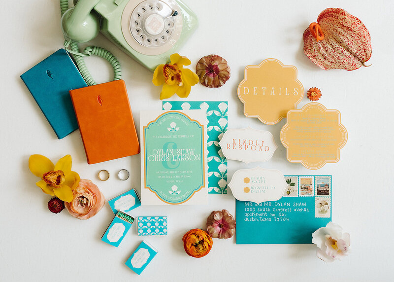 Colorful wedding invitation suite with turquoise, orange, and yellow details, modern die-cut cards, vintage stamps, and playful floral accents, styled by Eventive Designs.

