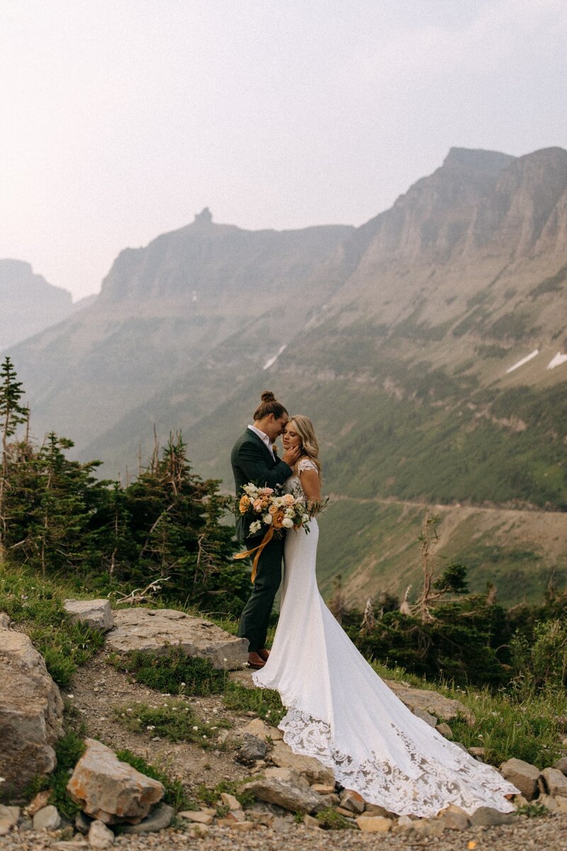 bride and groom posing in mountain valley