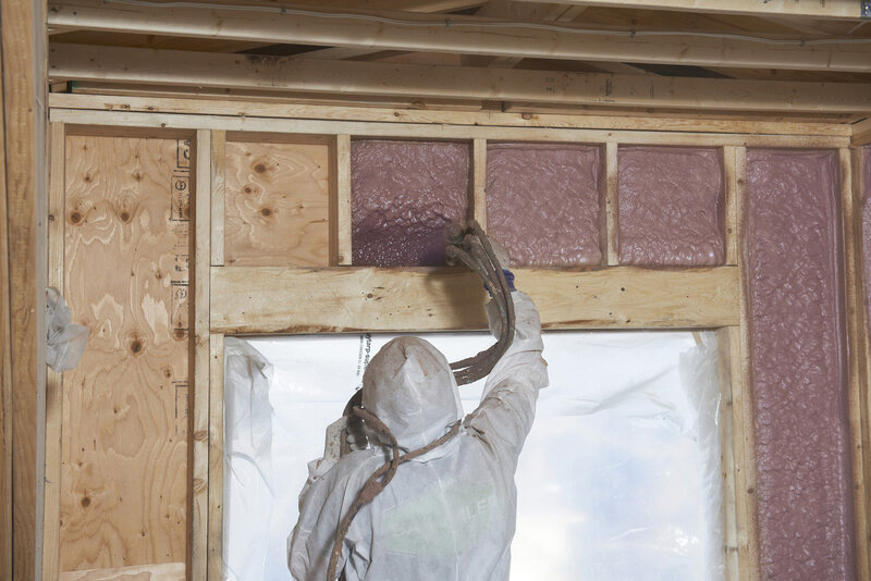 Installer spraying in insulation
