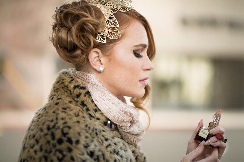 A woman applying eye makeup.