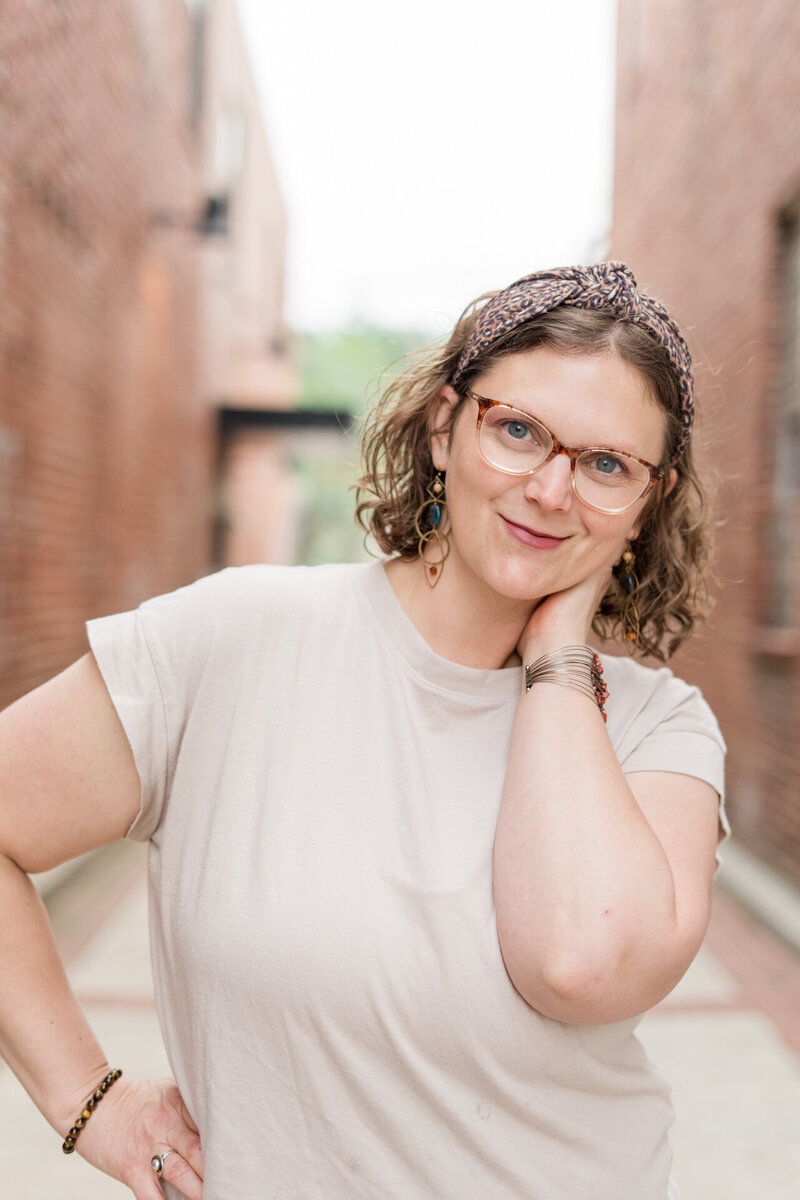 Boone, NC based family, wedding and boudoir photographer Ashley Kubota smiles at the camera.