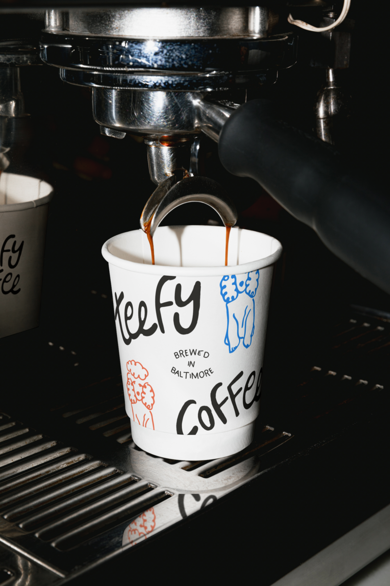 Teefy Coffee custom coffee cup under an espresso machine