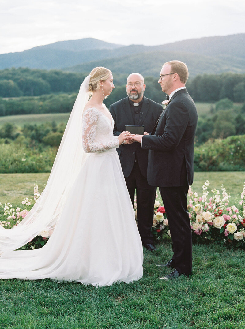 Bride and groom exchanging vows with mountain views, captured by a Multi-Day Wedding Photographer Virginia and Seattle-based.