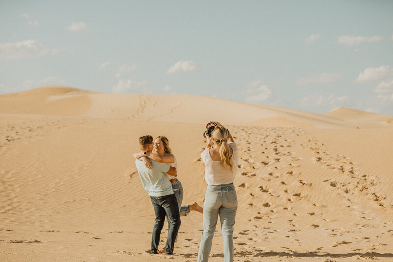 photographer with couple in desert