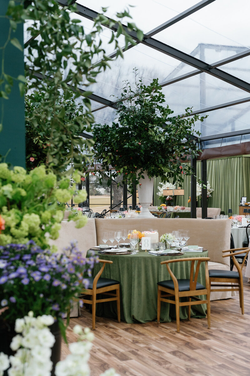 Tented wedding reception at Brook Hollow Golf Club in Dallas, with large couches and intimate seating areas