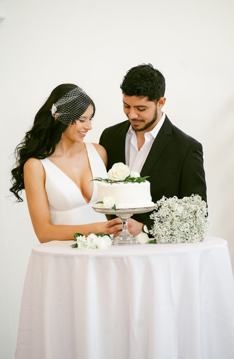 a couple cutting their cake at The Broadway Avenue in Grand Rapids with a Michigan wedding photographer