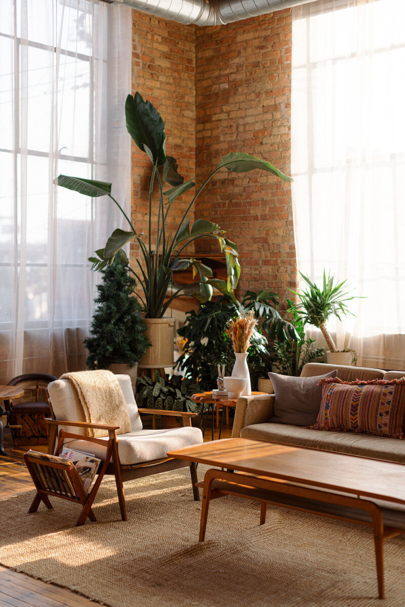 wide shot of an apartment with black walls and a brown couch
