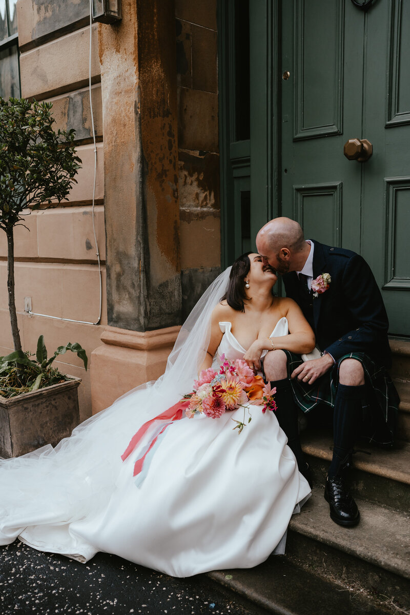 A newly married couple share a kiss at Netherbyres wedding venue