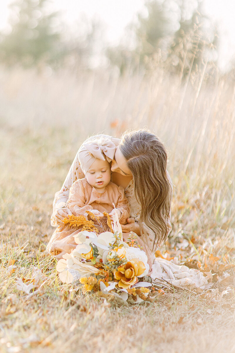 Mom snuggling her toddler for their fall family photos in Kansas City