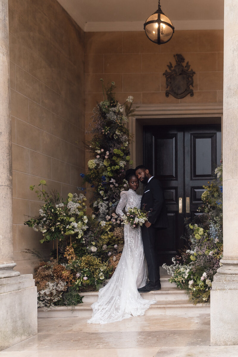 The bride Jessica hugging one of her wedding guests outside her intimate ceremony at The old Marleybone town hall in central London
